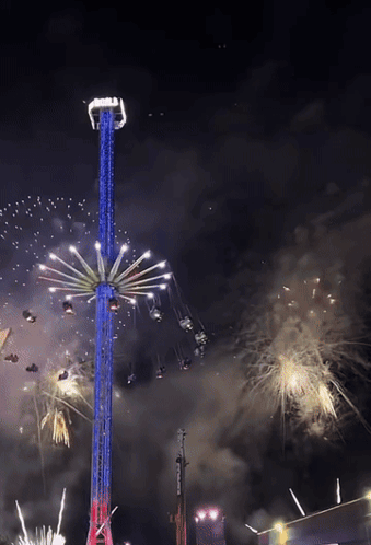 A Ferris Wheel Is Lit Up In Red White And Blue GIF