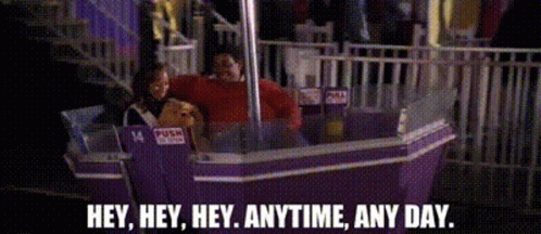 A Ferris Wheel With A Sign That Says Push Here GIF