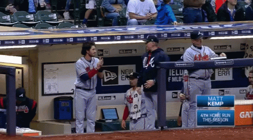 A Few Baseball Players Standing In A Dugout With A Sign That Says Matt Kemp GIF