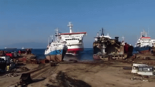 A Few Ships Are Sitting On A Beach And One Of Them Says ' Norwegian ' On The Side GIF