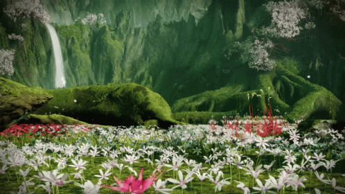 A Field Of Flowers With A Waterfall Behind It GIF