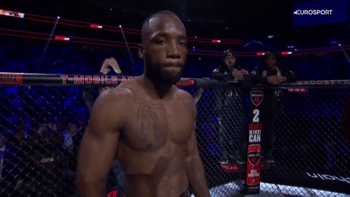 A Fighter In A Cage With A Sign That Says 2 Choice In Every Can On It GIF