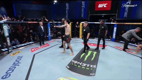 a fighter in a ufc ring with a monster energy can on the ground