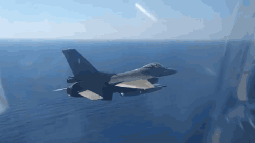 Fighter Jet Flying Over Ocean Under Blue Sky GIF