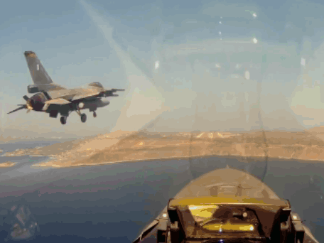 a fighter jet is flying over a body of water with mountains in the background