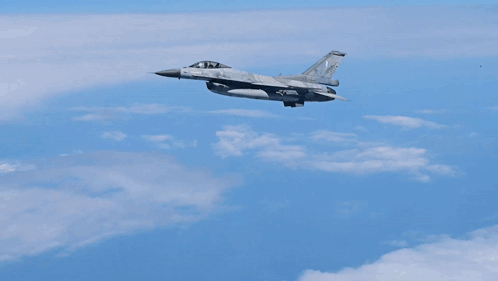 a fighter jet is flying through a blue sky with the number 24 on the tail