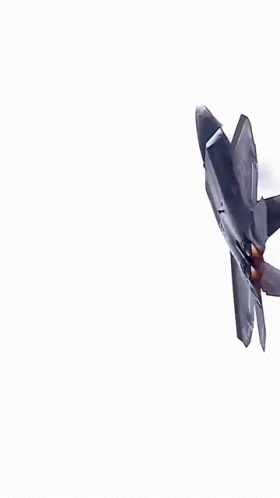 A Fighter Jet Is Flying Through A Blue Sky With White Clouds GIF