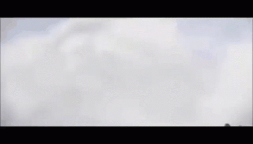 a fighter jet is flying through a cloudy sky .