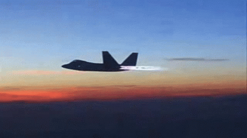 A Fighter Jet Is Flying Through A Cloudy Sky GIF