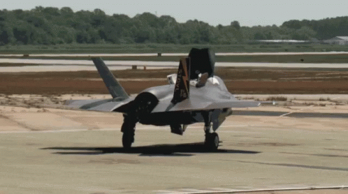 A Fighter Jet Is Taking Off From A Runway With The Letters Aa Visible On The Tail GIF