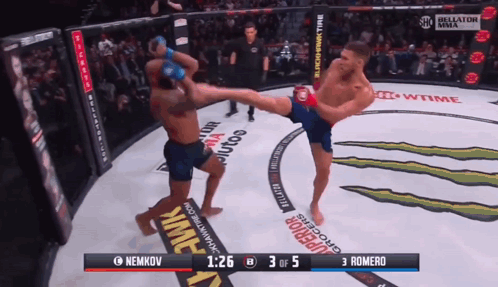 A Fighter Kicking Another Fighter In A Boxing Ring With The Score Of 3 To 5 GIF