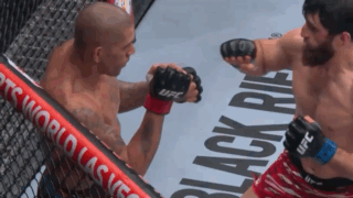 A Fighter Wearing Ufc Gloves Throws A Punch Against Another Fighter GIF