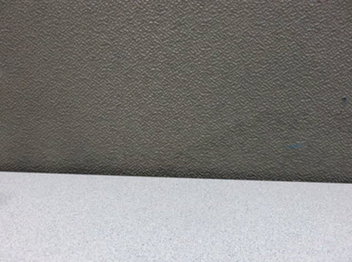 A Figurine Of A Man In A Suit And Hat Is Standing On A Table GIF