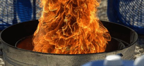 A Fire Is Coming Out Of A Garbage Can GIF