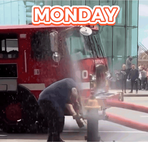 A Fire Truck Is Spraying Water On A Man 'S Head And The Words Monday Are Above It GIF