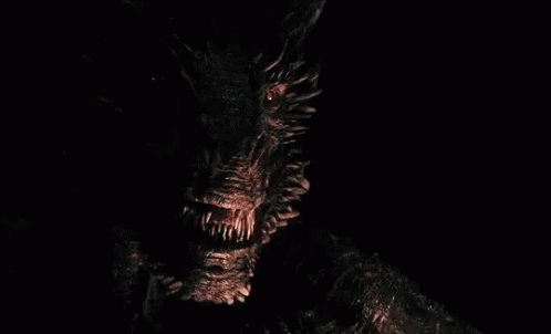 A Fireball Is Coming Out Of A Monster 'S Mouth In The Dark . GIF