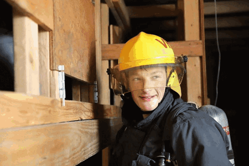a firefighter wearing a yellow helmet with the letter n on it