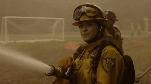 A Firefighter With A Cal Fire Badge On Her Chest GIF