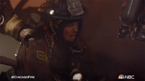 A Fireman With The Number 51 On His Helmet Holds A Flashlight GIF