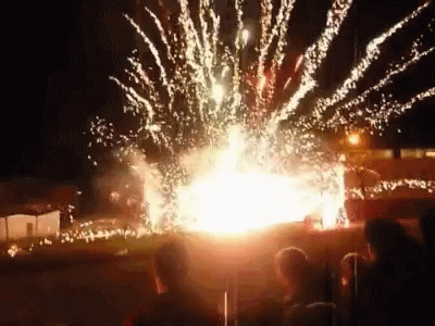 A Fireworks Display Is Being Watched By A Group Of People GIF