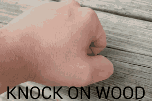 a fist is shown with the words knock on wood above it
