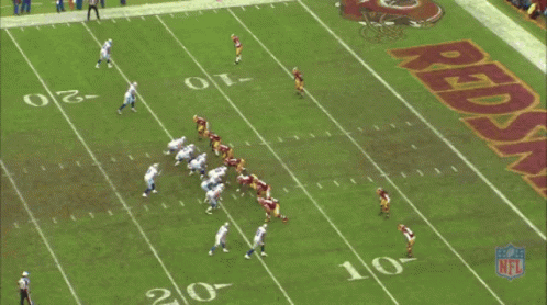 A Football Field With A Large Redskins Logo On It GIF