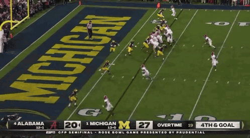 a football game between alabama and michigan is being shown on espn