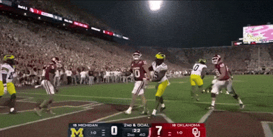A Football Game Between Michigan And Oklahoma Is Being Played GIF