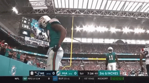 A Football Game Between The Miami Dolphins And The New York Jets Is Being Broadcast On Cbs GIF