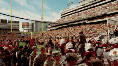 a football game is being played in a stadium that has a sign that says ' toyota ' on it