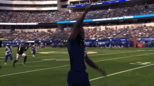 A Football Game Is Being Played In A Stadium That Has The Word Cowboys On The Scoreboard GIF