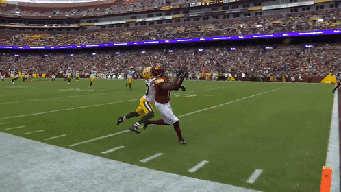 A Football Game Is Being Played In A Stadium With A Fedex Sign In The Background GIF