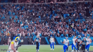 A Football Game Is Being Played In A Stadium With A Large Crowd Watching . GIF