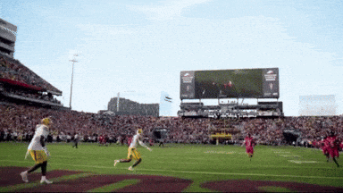 a football game is being played in a stadium with a scoreboard that says ram