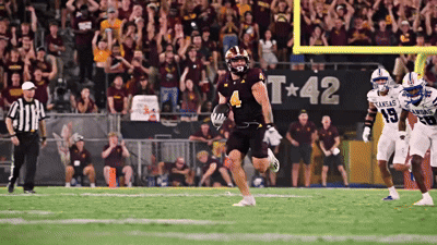 a football game is being played in front of a banner that says kansas
