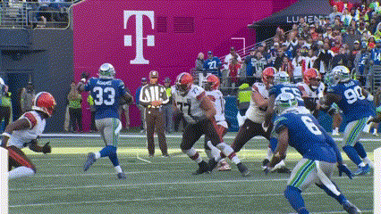 A Football Game Is Being Played In Front Of A Large T Mobile Sign GIF