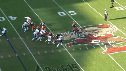 a football game is being played on a field that has the number 15 on it