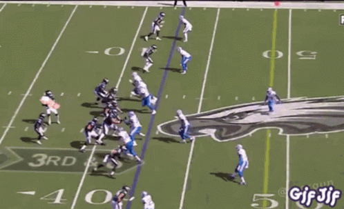 A Football Game Is Being Played On A Field With A Bunch Of People Watching . GIF