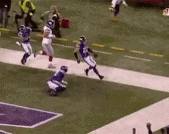 a football game is being played on a field with players running down the field .