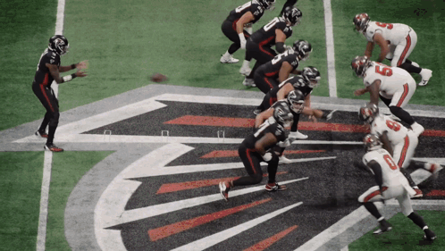 A Football Game Is Being Played On A Field With The Falcons Logo In The Background GIF