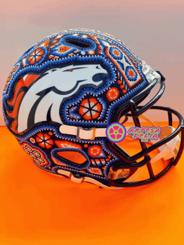A Football Helmet With A Denver Broncos Logo Painted On The Front GIF