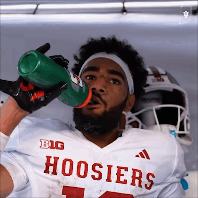 A Football Player Drinking From A Gatorade Bottle GIF