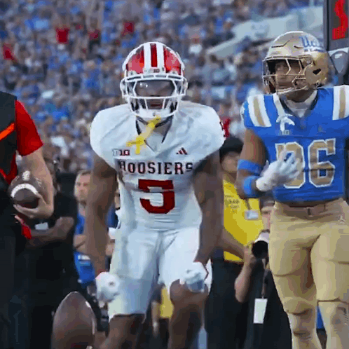 A Football Player For The Hoosier 'S Is Running With The Ball GIF