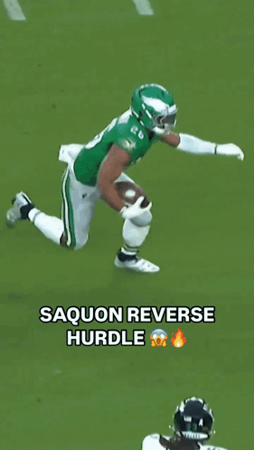 A Football Player In A Green Jersey Is Being Tackled By Another Player In White GIF