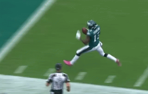 A Football Player In A Green Uniform With The Number 8 On It GIF