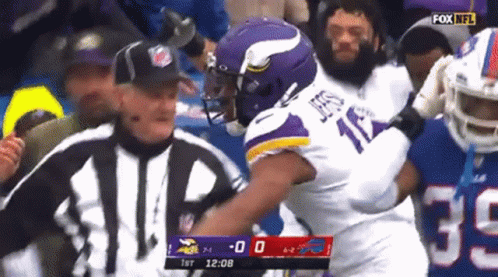 A Football Player In A Purple Jersey With The Number 17 On It GIF