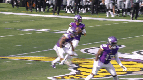 A Football Player In A Purple Jersey With The Number 23 On The Back GIF