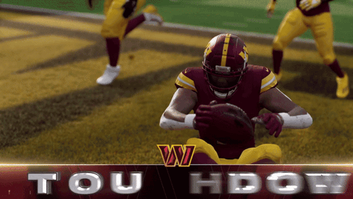 A Football Player In A Red And Yellow Uniform Holds A Ball In His Hands GIF