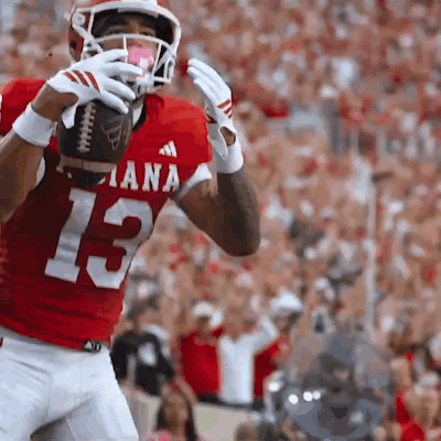 A Football Player In A Red Jersey With The Number 13 GIF
