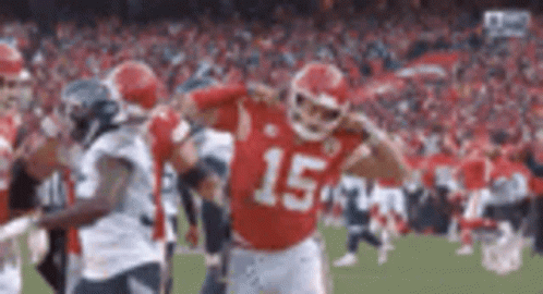 A Football Player In A Red Jersey With The Number 15 On It Is Standing On A Field . GIF